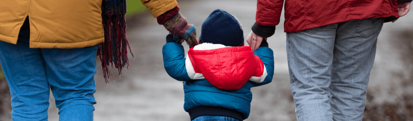 Child Walking With Parents Photo